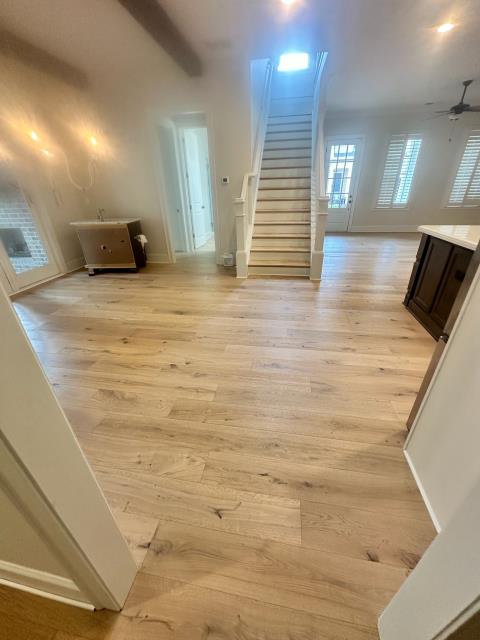 We installed new glue down engineered white oak in this home in Alpharetta, GA and also stained the stairs to match. 