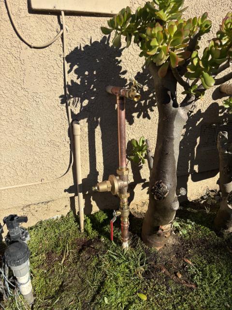 Rebuilt main riser to home with new 1 inch ball valve, double union pressure regulator, tee and hose bib. Reconnected to 3/4 inch irrigation supply. Set pressure to 65 psi. 1 year warranty on workmanship. Replaced 3/4 inch hose bib in backyard. 1 year warranty on workmanship.