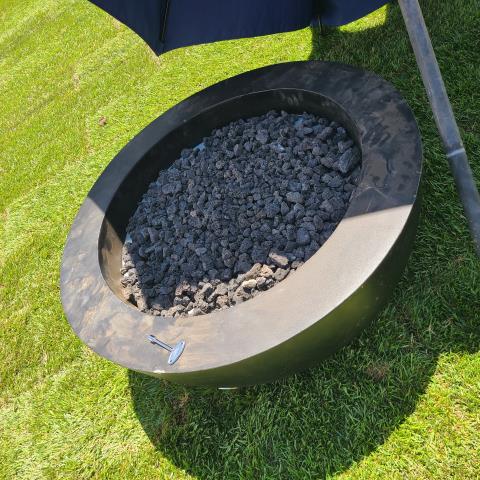Installing customer-supplied fireplace. Set fire pit in the designated area and provided necessary materials to connect and ensure proper operation.