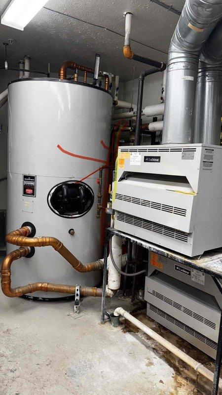 Completed service call to replace mixing valve on boiler system. Accessed mechanical room containing water heater tank and dual HVAC units to perform the necessary replacement. System functioning properly after service.