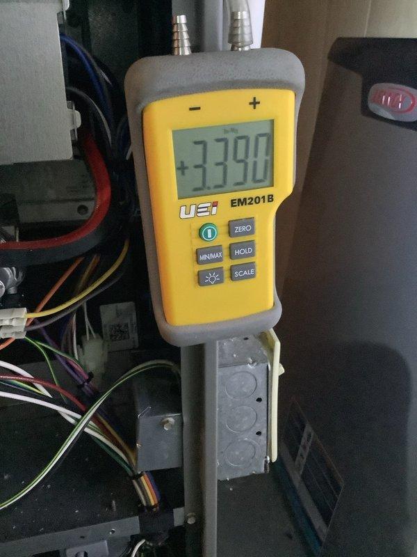Performed routine maintenance on 8-year-old MVP gas furnace. Conducted electrical diagnostics showing normal readings (+3390) using UEI EM201B meter. Inspected blower assembly, wiring connections, and verified proper system operation.