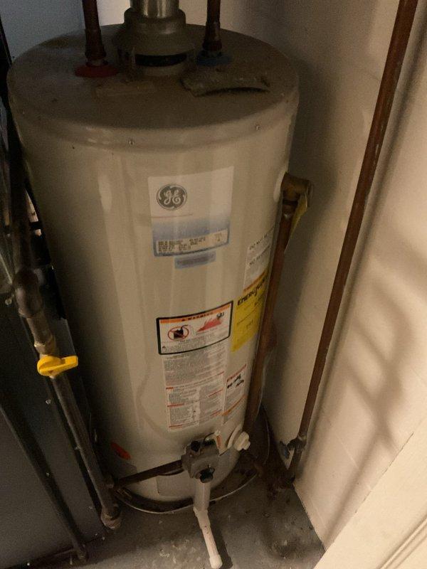 Responded to service call for no hot water. Upon inspection, found GE water heater with temperature setting issues. Adjusted thermostat and verified proper gas valve position. System now producing hot water normally.