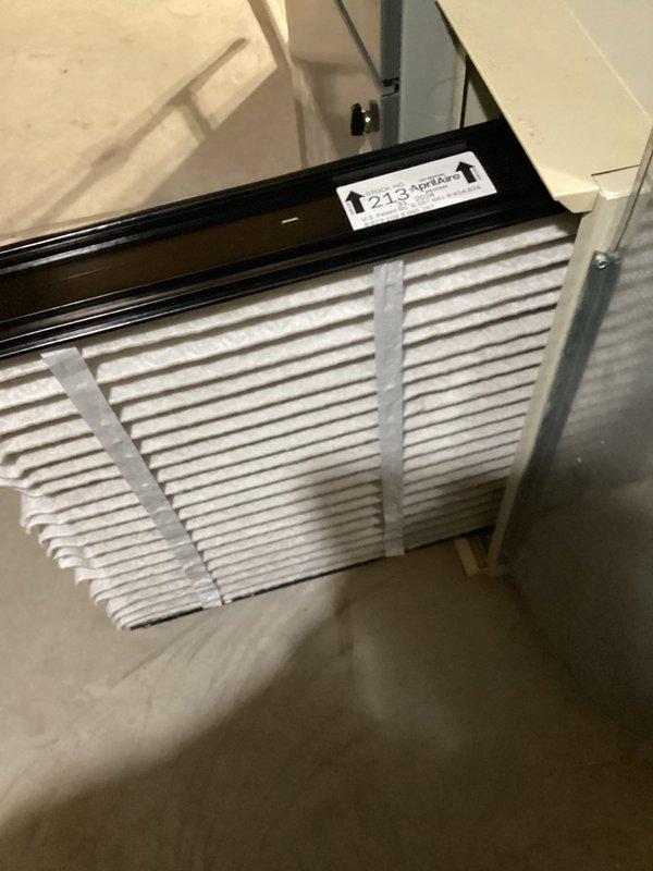 Performed scheduled furnace tune-up service. Inspected air filter, which appeared clean and properly installed with correct airflow orientation. Verified operation of APCO whole-house air purifier system mounted on the air handler, confirming proper installation and electrical connections to the UV treatment unit.