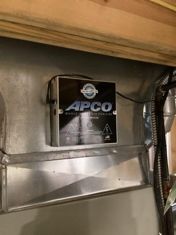 Performed scheduled furnace tune-up service. Inspected air filter, which appeared clean and properly installed with correct airflow orientation. Verified operation of APCO whole-house air purifier system mounted on the air handler, confirming proper installation and electrical connections to the UV treatment unit.