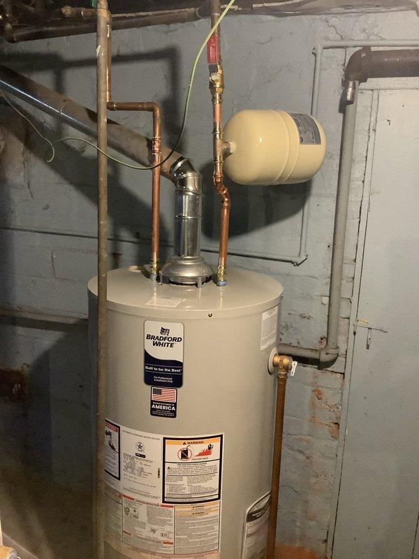 Completed installation of a new 40-gallon Bradford White water heater with 6-year warranty, including new shut-off valves and thermal expansion tank. Also replaced main water supply valve with new quarter-turn ball valve and installed pressure reducing valve for improved water pressure regulation.