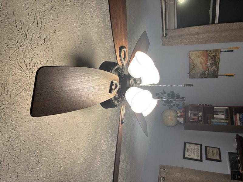 Successfully installed customer-provided ceiling fan with light kit in residential room. Properly mounted unit to existing electrical box in textured ceiling and verified full functionality of both fan and lighting components. All connections were secured according to manufacturer specifications and unit was tested for proper operation before completion.