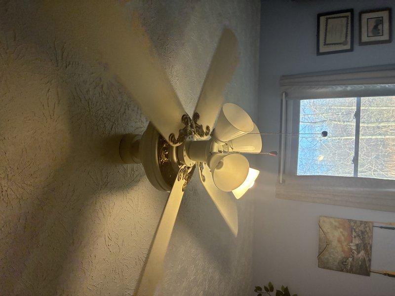 Successfully installed customer-provided ceiling fan with light kit in residential room. Properly mounted unit to existing electrical box in textured ceiling and verified full functionality of both fan and lighting components. All connections were secured according to manufacturer specifications and unit was tested for proper operation before completion.