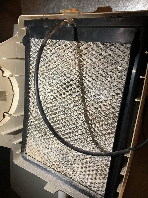 Performed routine maintenance on gas furnace of undetermined age. Inspected air filter, which showed normal dust accumulation, and examined heat exchanger connections. Noted some mineral buildup at copper pipe fittings that should be monitored but are functioning properly. System is operational and working as expected.