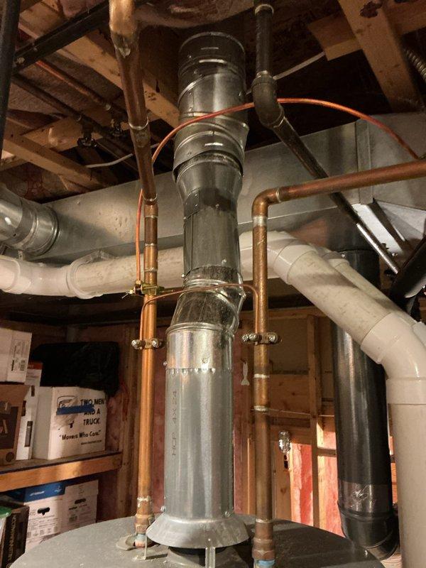 Diagnosed and repaired water heater with melted plastic rings on one side. Inspected ventilation system, including galvanized flue pipe and copper supply lines, to identify heat transfer issues causing plastic component damage. Replaced damaged parts and verified proper ventilation clearance to prevent future overheating problems.