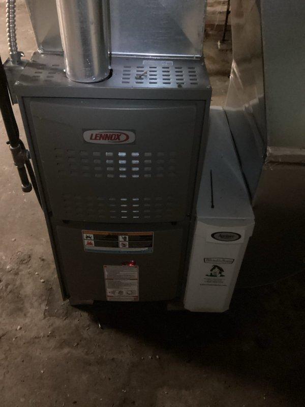 Performed routine maintenance service on Lennox furnace system in basement. Inspected unit functionality, checked ventilation systems, and replaced filter with Spaceguard 413 model. System appears to be operating within normal parameters with humidifier attachment in good working condition.