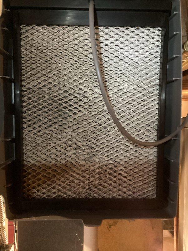 Completed scheduled heating maintenance service on the HVAC system. Inspected internal electrical components including wiring harness, control valve, and circuit board connections. Examined air filter which showed signs of accumulation and discoloration, indicating normal usage and proper filtration function.