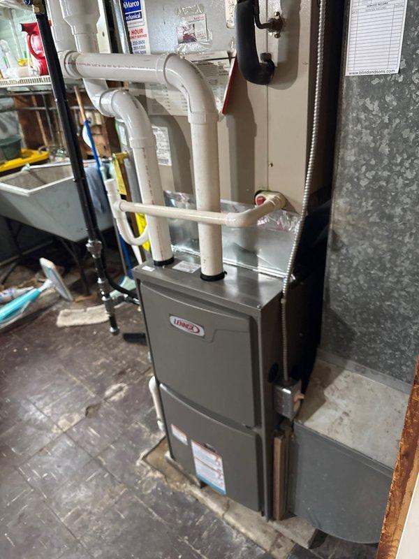 Successfully installed a 90% efficient Lennox furnace in customer's basement utility room, including proper connection to existing ductwork and installation of PVC intake and exhaust ventilation system. Unit was positioned appropriately near water heater with all electrical connections and control wiring completed according to manufacturer specifications.