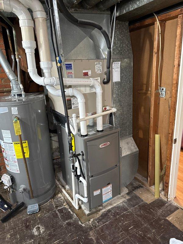Successfully installed a 90% efficient Lennox furnace in customer's basement utility room, including proper connection to existing ductwork and installation of PVC intake and exhaust ventilation system. Unit was positioned appropriately near water heater with all electrical connections and control wiring completed according to manufacturer specifications.
