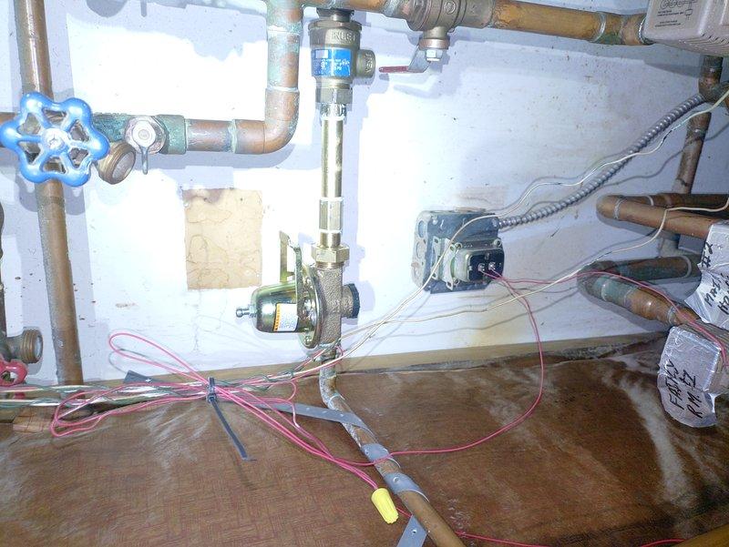Replaced faulty pressure reducing valve and installed new Extrol expansion tank on customer's hydronic heating system after identifying water damage to surrounding cabinetry. System required complete drain down and refill procedure to restore proper operation and prevent further leakage issues.