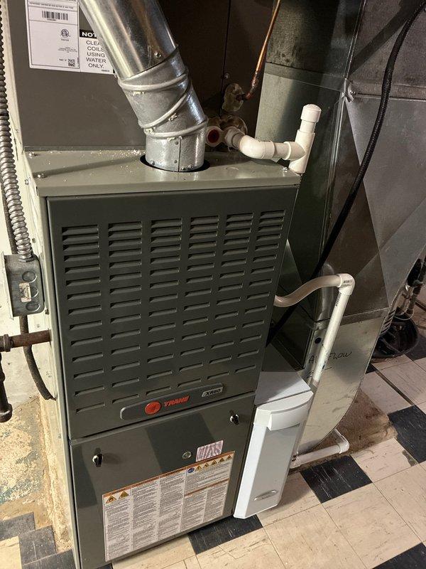 Performed recurring MVP Heating maintenance service on 5-year-old Trane furnace system. Conducted thorough inspection using hex key tool to access and check internal components. System appeared to be in good working condition with proper installation of ductwork, drainage pipes, and electrical connections.