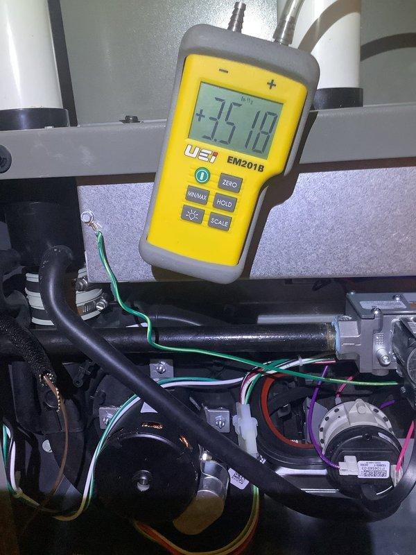 Completed routine MVP Heating maintenance service on a one-year-old system. Inspected air handler and filter housing, confirming filter is clean and properly installed. Measured temperature differential with UEi EM201B meter showing +35.10°F, indicating system is operating within normal parameters.