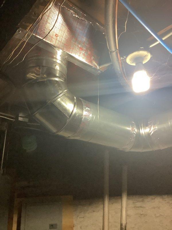 Completed installation of new return ductwork system in basement mechanical room, incorporating panning techniques and installation of a new 2410 unit. Work included connecting the system to existing HVAC infrastructure with proper metal ducting, joints, and elbow connections to ensure optimal airflow throughout the property.