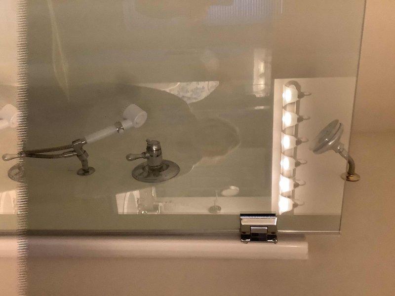 Inspected and repaired leaking shower head in upstairs bathroom, addressing visible water accumulation in bathtub. Additionally, identified and fixed leak under bathroom sink, ensuring all plumbing fixtures were properly sealed and functioning correctly.
