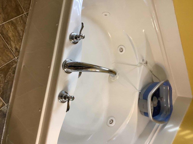 Completed linking of bathtub fixtures in master bathroom, which included installation of polished chrome control knobs with lever handles and curved spout. Verified proper water flow and connection integrity after installation, ensuring no leaks present.