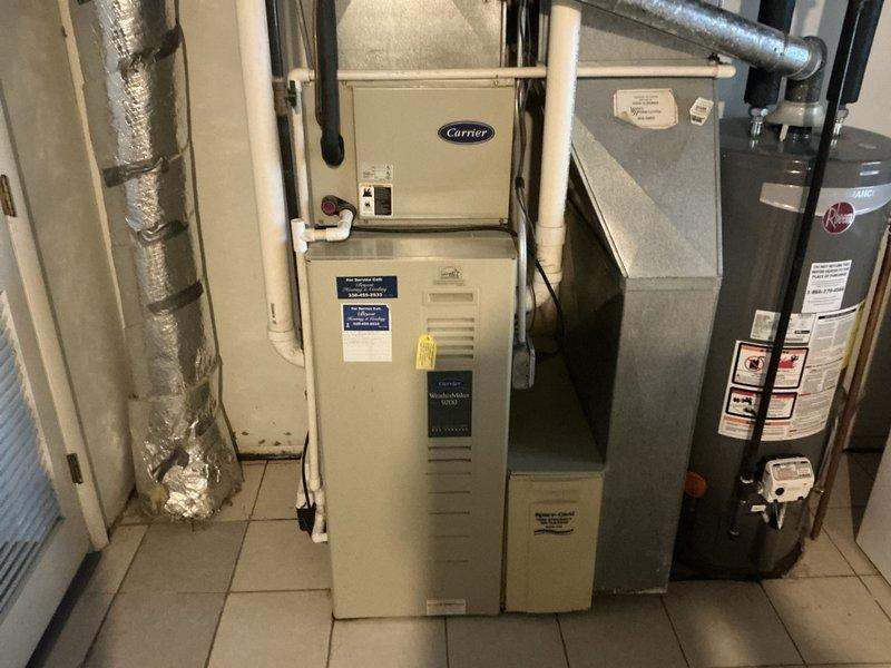 Performed site assessment of existing HVAC system, including a Carrier furnace and associated ductwork in utility room. Documented current equipment condition, evaluated existing insulated ductwork configuration, and inspected plumbing infrastructure connections to prepare comprehensive replacement estimate.