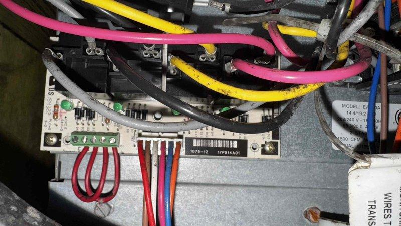 Performed routine maintenance on 10-year-old geothermal system that experienced multiple rollover events, most recently from 11/14 to 1/12. Inspected control board circuitry and electrical connections, documenting condition of terminal blocks and wiring. Confirmed system functionality with transformer connections intact and operational status of electronic components.