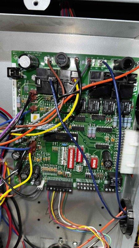 Performed routine maintenance on 10-year-old geothermal system that experienced multiple rollover events, most recently from 11/14 to 1/12. Inspected control board circuitry and electrical connections, documenting condition of terminal blocks and wiring. Confirmed system functionality with transformer connections intact and operational status of electronic components.