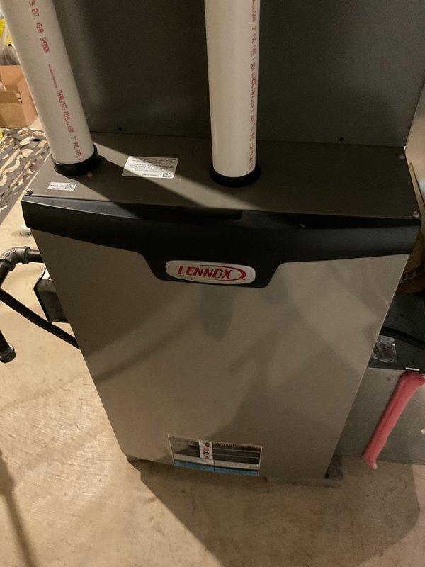 Performed annual maintenance service on 1-year-old Lennox furnace. Inspected gas valve assembly, examined electrical connections and wiring integrity. Visual inspection confirmed proper venting configuration with intake and exhaust PVC pipes in good condition. All components functioning within normal parameters.