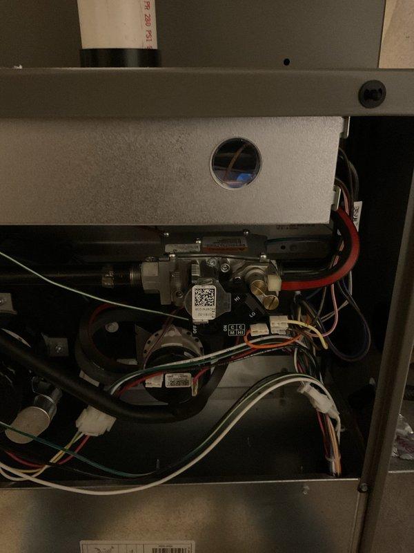 Performed annual maintenance service on 1-year-old Lennox furnace. Inspected gas valve assembly, examined electrical connections and wiring integrity. Visual inspection confirmed proper venting configuration with intake and exhaust PVC pipes in good condition. All components functioning within normal parameters.