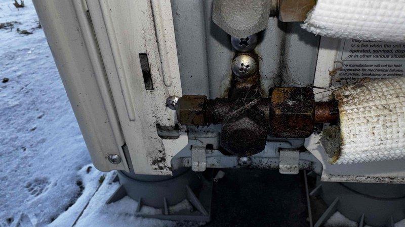 Responded to customer complaint regarding Mitsubishi BTU cooling unit not producing air flow (hot or cold). Upon inspection of outdoor unit, identified significant corrosion and deterioration on pipe fittings and valve assembly, likely due to exposure to winter conditions. Unit also showed signs of moisture accumulation and weathering that was affecting proper operation. Service completed on outdoor condenser to restore proper functionality.