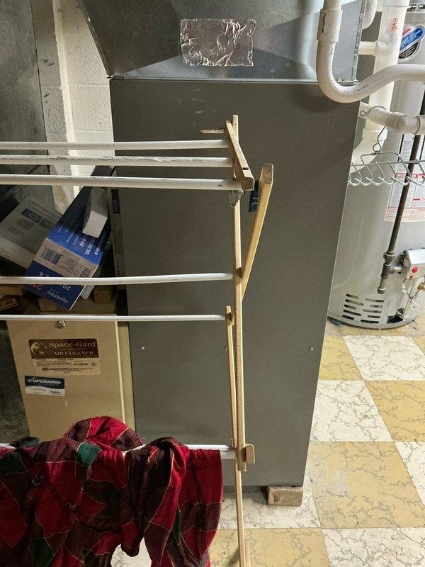 Completed estimate for replacement of a 17-year-old furnace with failed control board and leaking heat exchanger. Existing system includes a Space-Gard Air Cleaner in a basement utility area alongside water heater. Current installation shows signs of water damage on surrounding concrete block wall where PVC venting connects to the system.