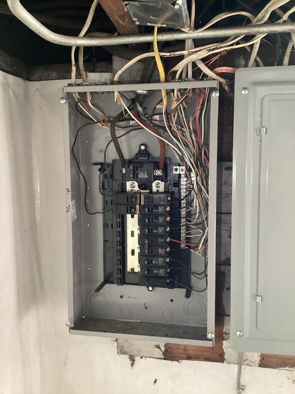 Diagnosed power outage issue at residence with no electricity to main panel. Upon inspection, discovered damaged weatherhead connection at meter base showing significant oxidation and exposed wiring components. Replaced weathered service entrance conductor connections and secured loose wiring in main distribution panel to restore electrical service to home.