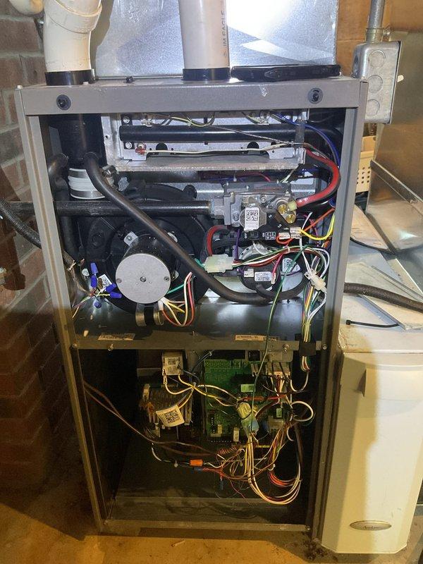 Performed scheduled MVP heating maintenance service. Opened furnace unit to access and inspect internal components including circuit board, blower motor assembly, and wiring connections. Conducted thorough examination of system while documenting condition with photos for service records.