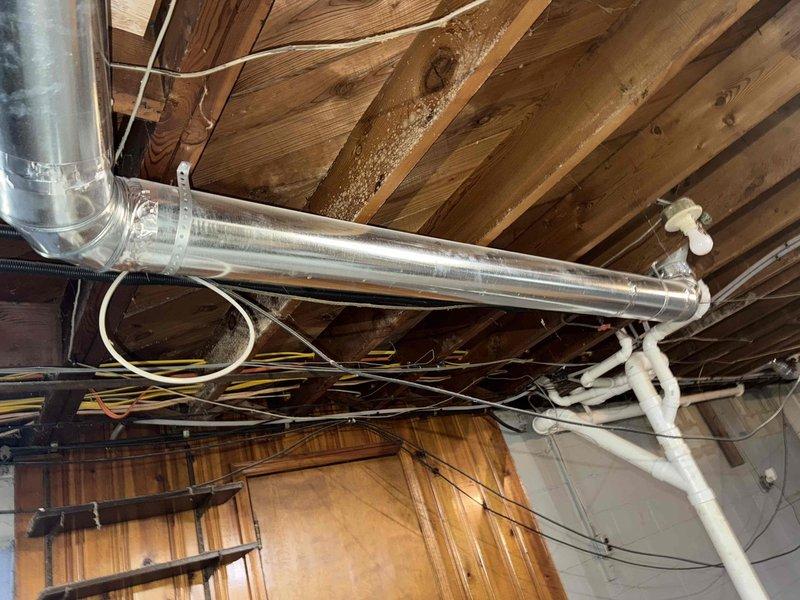 Performed diagnostic check on newly installed thermostat to verify proper functionality. Inspected ductwork system during service and identified significant rust/corrosion at one junction point that requires attention. Evaluated feasibility of adding additional vent to room as requested by customer; will require extension of existing ductwork through ceiling joists.
