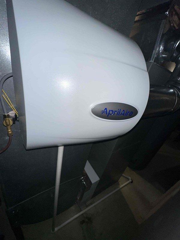 Installed new Aprilaire model 600 whole-home humidifier with all accompanying components on existing HVAC system per previous quote. Installation included proper connection of water supply line and integration with the home's ductwork system, utilizing a 90-degree elbow joint to ensure optimal airflow and humidity distribution.