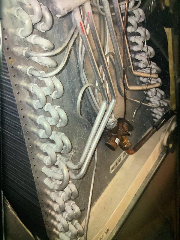 Performed scheduled heating maintenance on 1-year-old system. Identified significant frost accumulation on evaporator coils indicating possible restricted airflow. Inspected refrigerant lines and connection points, documenting condition of copper fittings and valves for future reference.