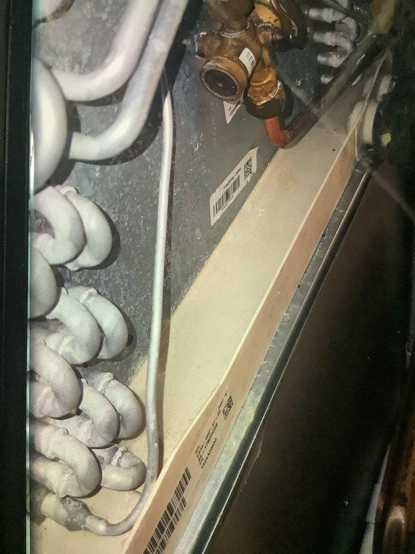 Performed scheduled heating maintenance on 1-year-old system. Identified significant frost accumulation on evaporator coils indicating possible restricted airflow. Inspected refrigerant lines and connection points, documenting condition of copper fittings and valves for future reference.