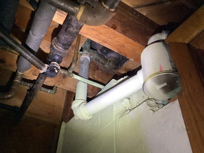 Responded to service call for MVP customer with clogged bathtub drain and garbage disposal issues. Inspected existing plumbing infrastructure in basement/crawl space, including cast iron and PVC drainage components. Discovered ventilation system integration with drainage architecture that was contributing to clogging issues. Successfully cleared bathtub drain obstruction and verified proper function of garbage disposal unit.