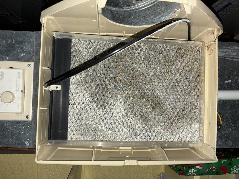 Responded to service call for recurring humidifier leak. Inspection revealed severely clogged air filter causing system restriction, leading to water overflow. Replaced filter, cleaned housing assembly, and verified proper drainage function. System operating normally after service with no further leakage detected.