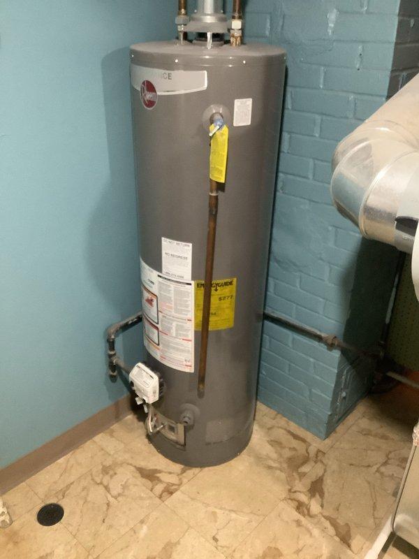 Inspected existing 11-year-old 40-gallon Rheem water heater in basement for potential replacement. Unit appears functional but reaching end of service life. Customer requesting upgrade to 50-gallon capacity. Current installation includes standard copper pipe connections, proper venting, and appears code-compliant. Provided estimate for new 50-gallon water heater installation including removal of old unit, new fittings, and required updates to meet current plumbing standards.