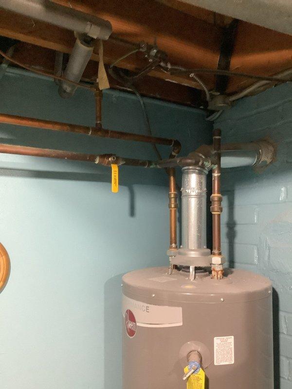 Inspected existing 11-year-old 40-gallon Rheem water heater in basement for potential replacement. Unit appears functional but reaching end of service life. Customer requesting upgrade to 50-gallon capacity. Current installation includes standard copper pipe connections, proper venting, and appears code-compliant. Provided estimate for new 50-gallon water heater installation including removal of old unit, new fittings, and required updates to meet current plumbing standards.