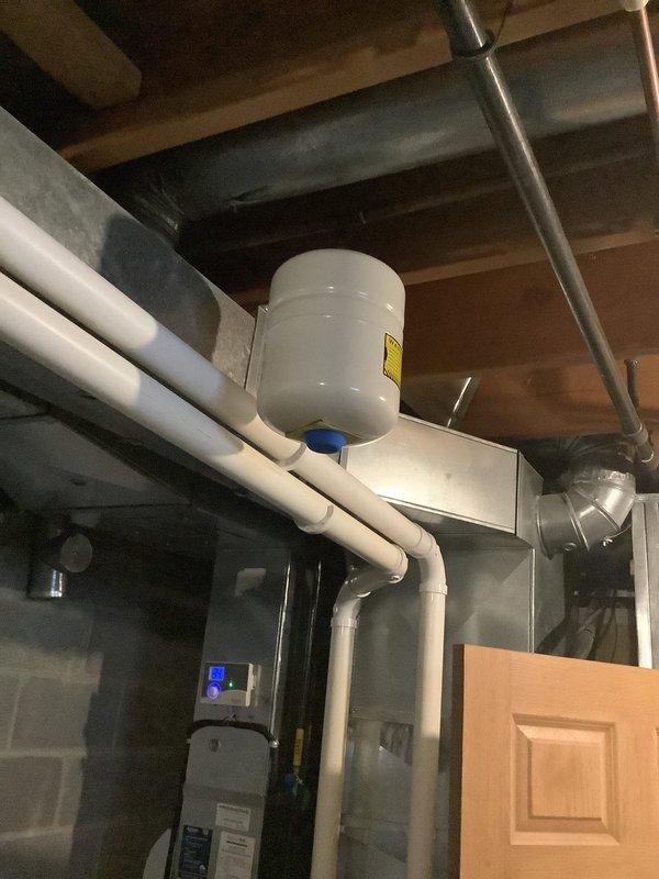 Replaced ruptured 2.1-gallon pressure tank in utility room. Installed new pressure tank to existing PVC and copper pipe system. Verified proper pressure readings on gauge after installation.