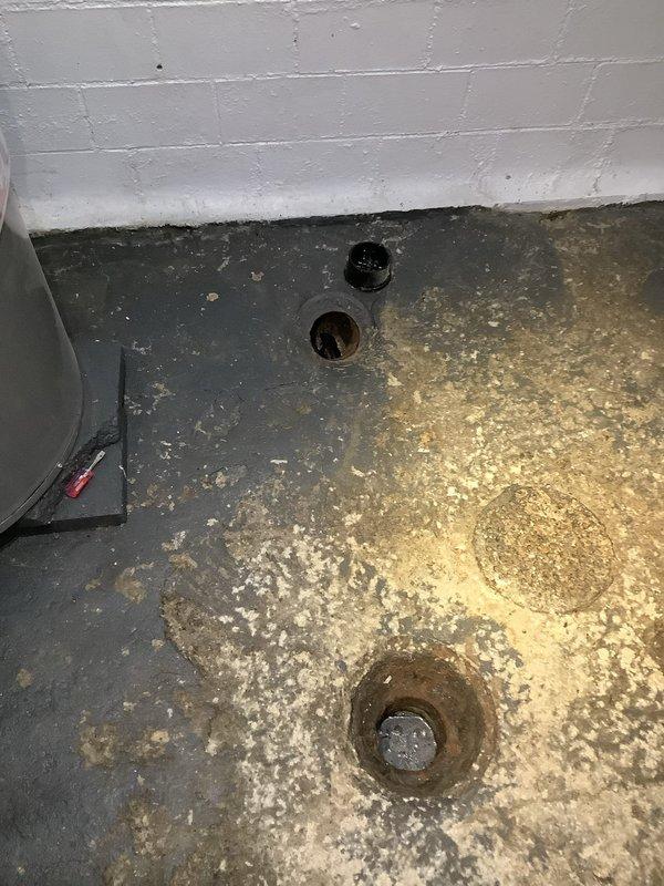 Performed camera inspection of main drain line after customer reported possible clogging issue. Located main cleanout access point in basement along with floor drains showing signs of backup/mineral deposits. Visual inspection revealed sediment accumulation at pipe base and discoloration around drain openings, consistent with periodic drainage issues.