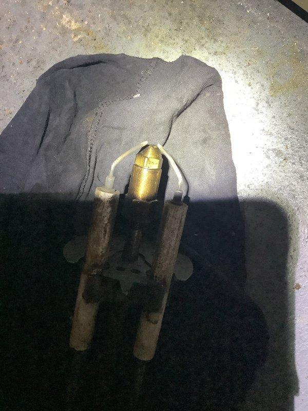 Responded to no-heat call for 10+ year old oil furnace. Diagnosed system after customer confirmed oil delivery was completed. Removed front panel to inspect internal components and identified fuel delivery issue. Removed and inspected pilot assembly, cleaned connections, and restored proper operation. System now functioning normally with adequate heat production.