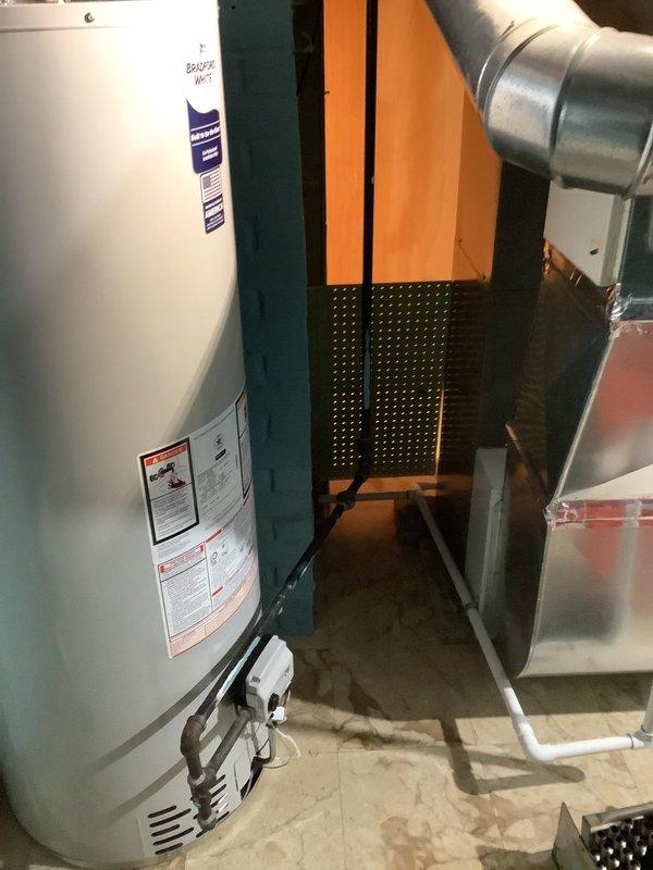 Successfully installed a new 50-gallon Bradford White water heater in basement utility area. Installed required code-compliant thermal expansion tank. System includes properly connected copper piping and metal ventilation with appropriate insulation.