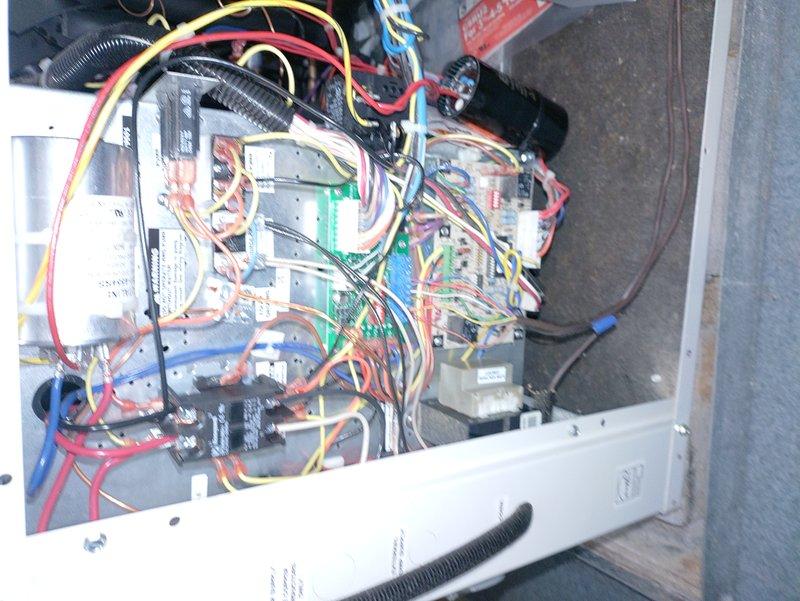 Performed scheduled maintenance on 13-year-old geothermal heating system. Inspected electrical control panel components and wiring connections in confined space. System functioning properly with maintenance validity extending to 2025.