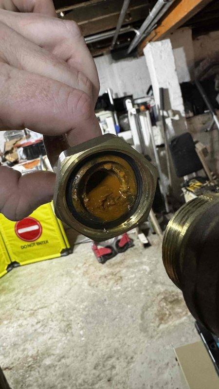 Responded to no-heat call for 2.5-year-old boiler system. Diagnosed issue as sediment buildup in brass fittings causing flow restriction. Removed and cleaned affected components, restoring proper circulation and system functionality.