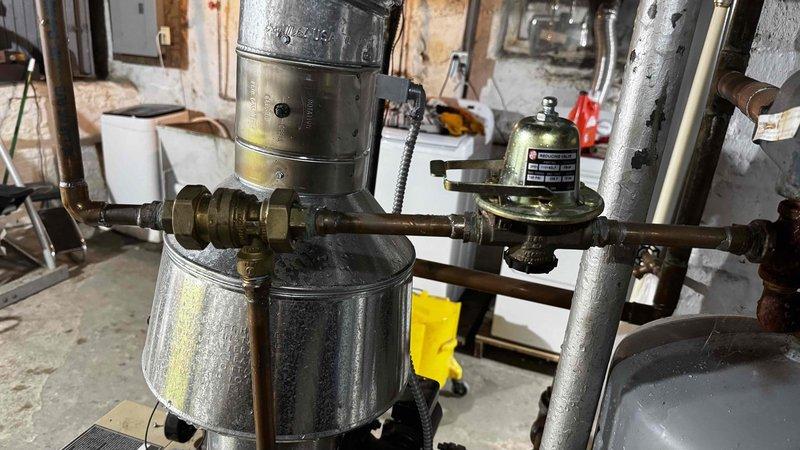 Responded to no-heat call for 2.5-year-old boiler system. Diagnosed issue as sediment buildup in brass fittings causing flow restriction. Removed and cleaned affected components, restoring proper circulation and system functionality.