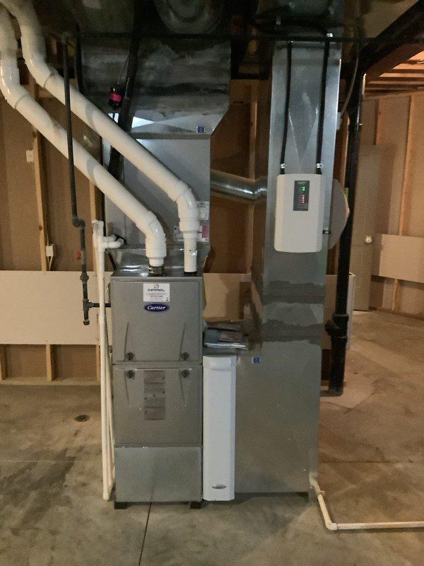 Completed installation of new 90K BTU furnace with humidifier and outdoor AC unit on existing Aprilaire zoning system. Installed three new thermostats and verified proper damper operation during system startup. All components functioning correctly with proper ventilation connections and control integration.