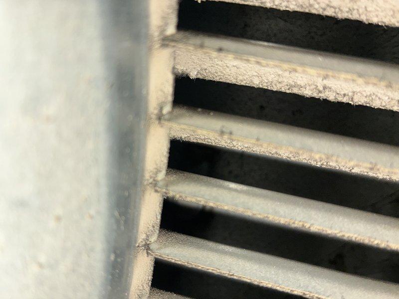 Performed routine heating maintenance service on 13-year-old HVAC system. Inspected ventilation components and identified dust accumulation on cooling fins. Examined insulation material which appears to be in standard condition with no visible damage.