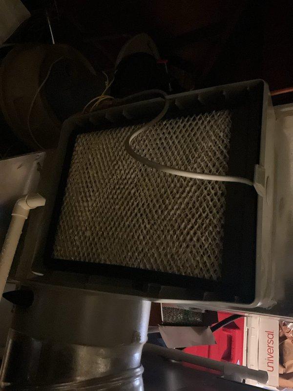 Performed scheduled BS-MVP heating maintenance visit on 4-year-old system. Inspected and documented condition of evaporator/humidifier pad filter assembly, which showed typical wear. Used hex key tool to access and service system components during the routine maintenance inspection.